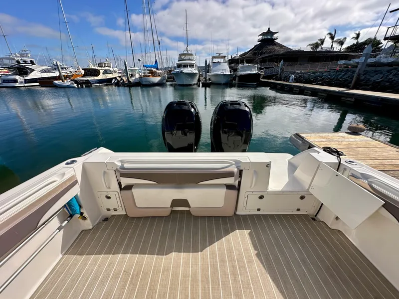 Slide: The Image of 2018 Wellcraft 290 Coastal boat docked at marina with twin engines. - 16
