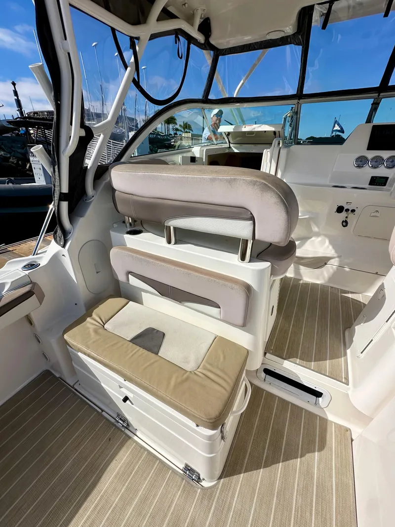 Slide: The Image of 2018 Wellcraft 290 Coastal boat interior with seating and dashboard, featuring modern design elements. - 17