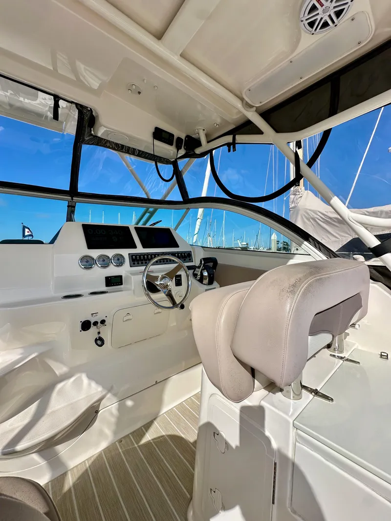 Slide: The Image of Interior of 2018 Wellcraft 290 Coastal boat, featuring helm and seating. - 19