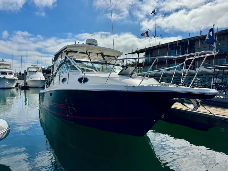 Slide: The Image of 2018 Wellcraft 290 Coastal boat docked in a marina under a blue sky. - 2