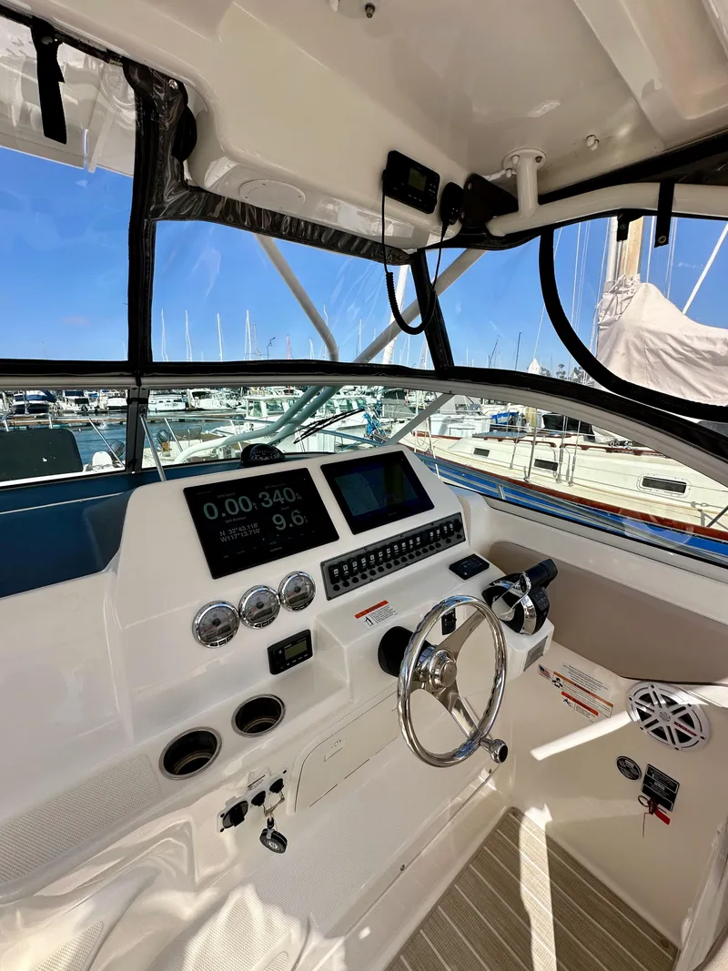 Slide: The Image of 2018 Wellcraft 290 Coastal boat dashboard with modern controls and navigation displays. - 20