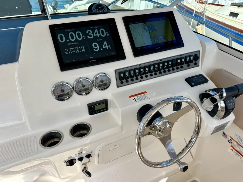 Slide: The Image of 2018 Wellcraft 290 Coastal helm with GPS displays, gauges, and steering wheel. - 21