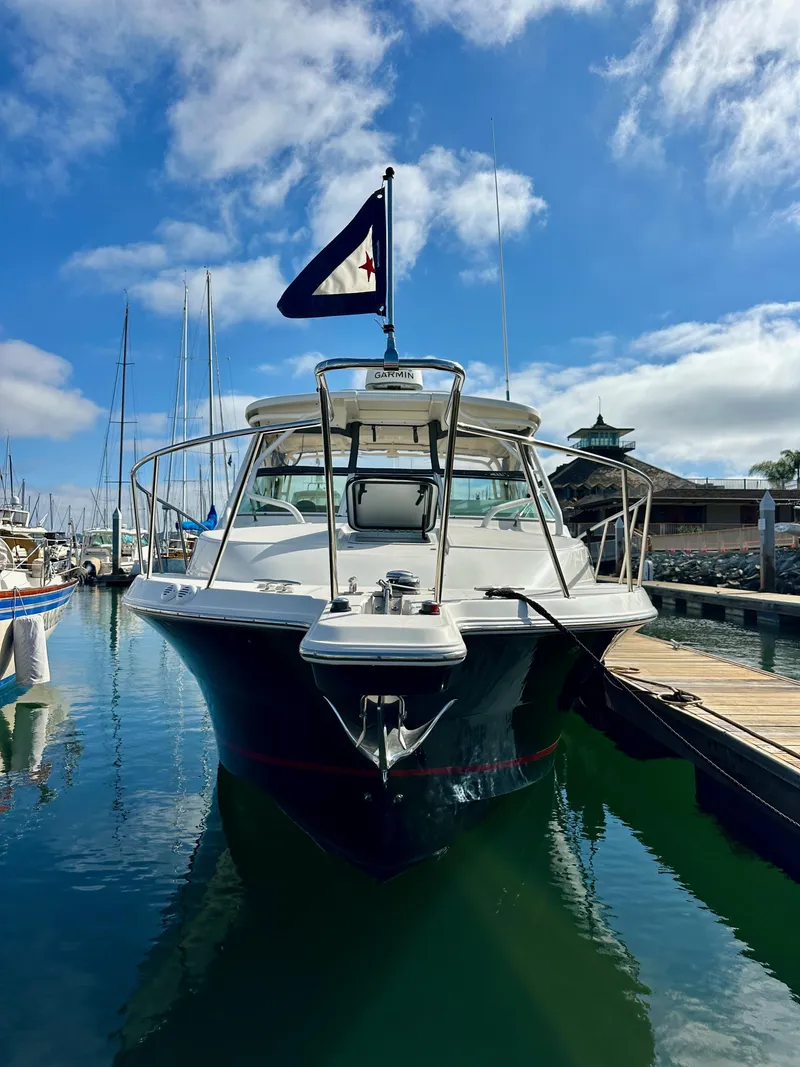 Slide: The Image of 2018 Wellcraft 290 Coastal boat docked in a marina under a clear blue sky. - 3
