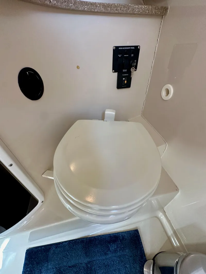 Slide: The Image of 2018 Wellcraft 290 Coastal boat bathroom with toilet and accessory panel. - 37
