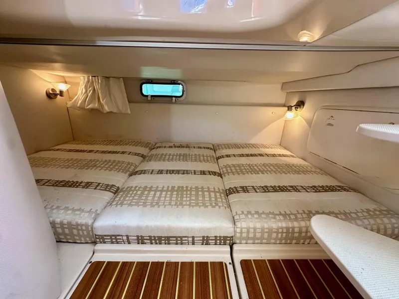 Slide: The Image of 2018 Wellcraft 290 Coastal cabin interior with cozy bedding and ambient lighting. - 38