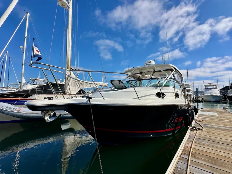 Slide: The Image of 2018 Wellcraft 290 Coastal boat docked at marina under blue sky. - 4