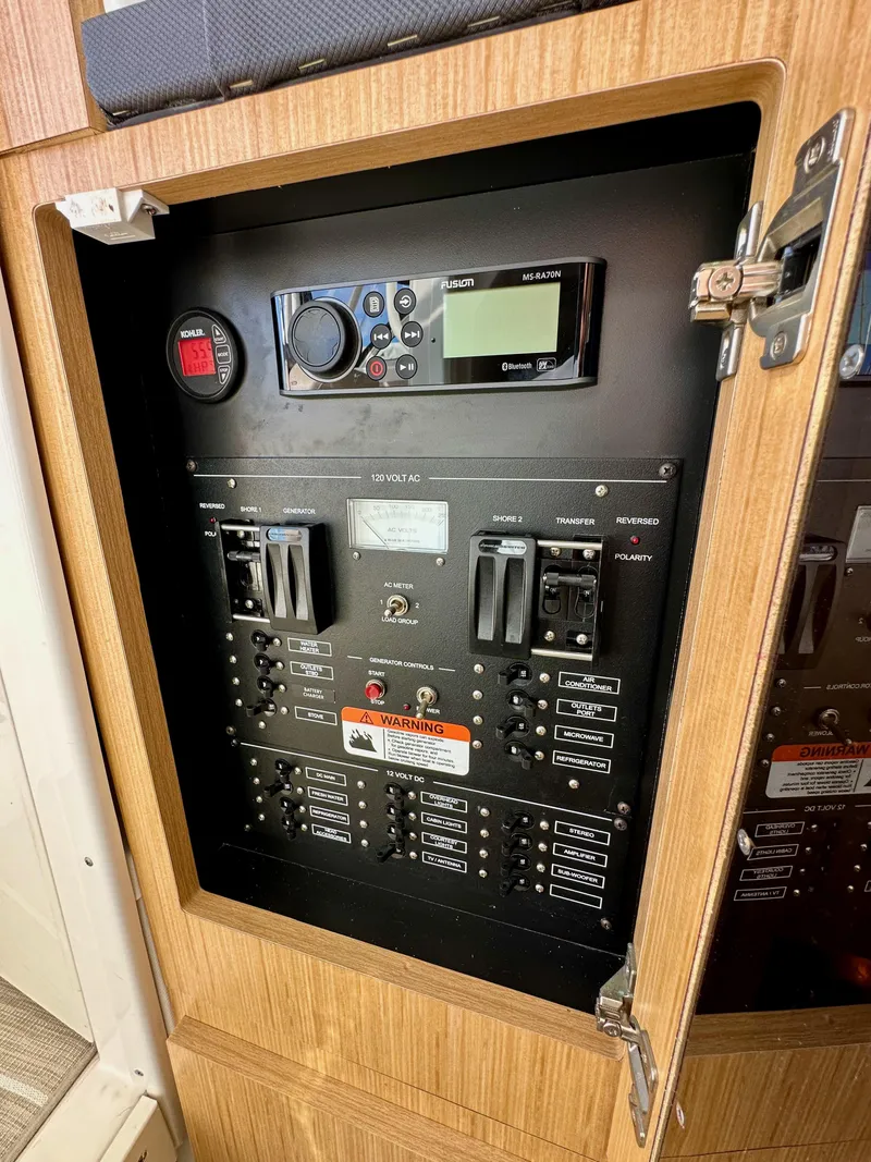 Slide: The Image of Electrical control panel inside a 2018 Wellcraft 290 Coastal boat cabin. - 40