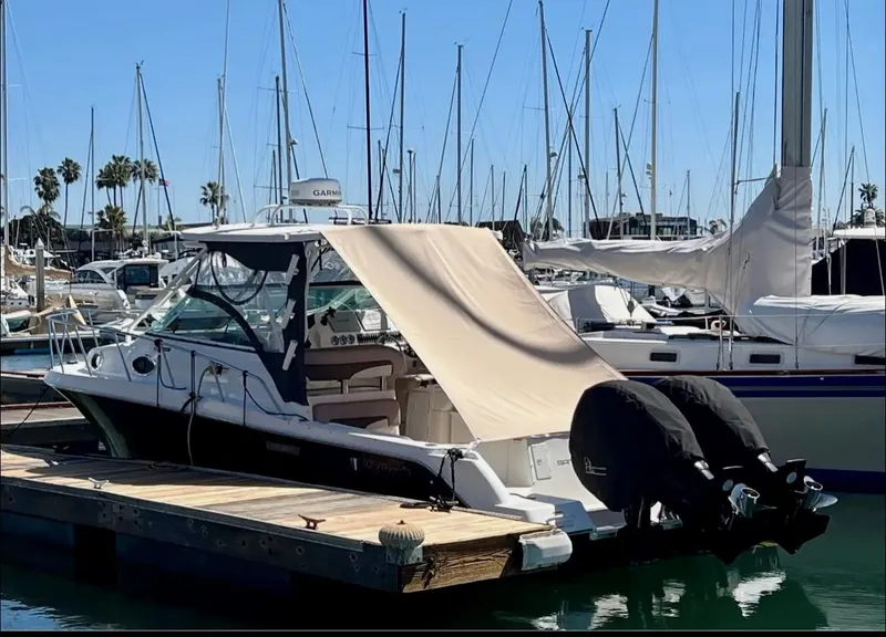 Slide: The Image of 2018 Wellcraft 290 Coastal boat docked at marina with covered outboard motors. - 42