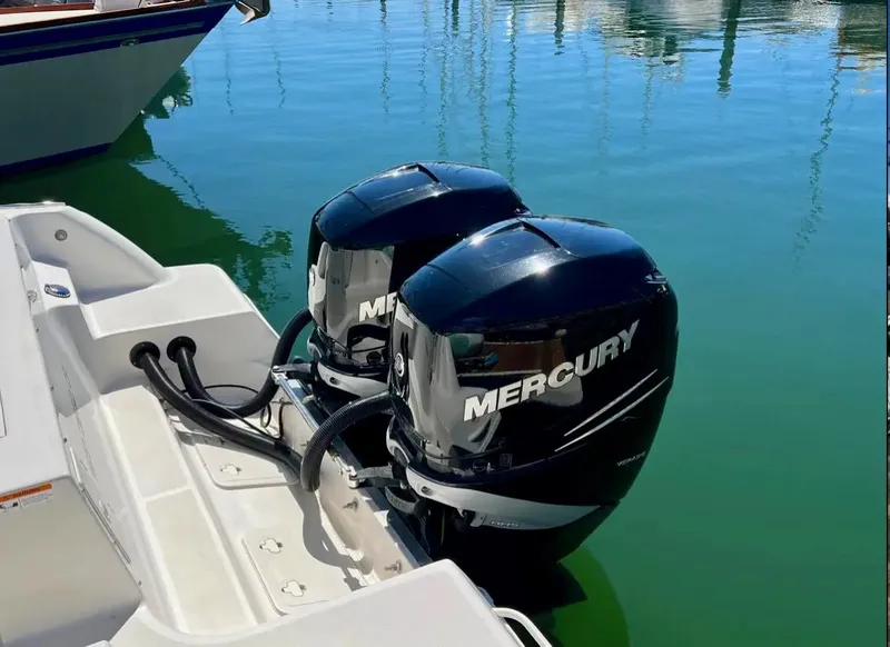 Slide: The Image of Twin Mercury outboard engines on a 2018 Wellcraft 290 Coastal boat in a marina. - 44
