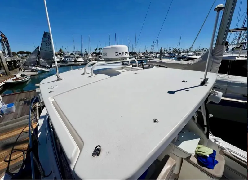 Slide: The Image of 2018 Wellcraft 290 Coastal boat docked at marina with clear blue sky. - 45