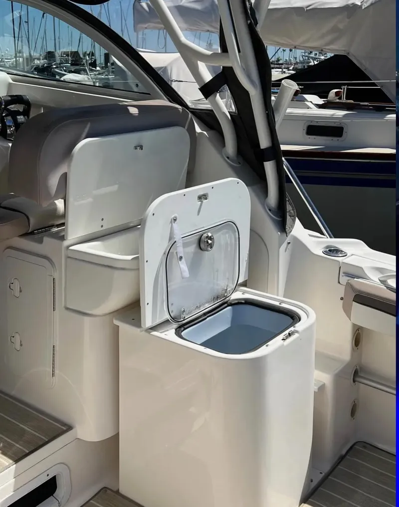 Slide: The Image of 2018 Wellcraft 290 Coastal boat interior with open storage compartment. - 48