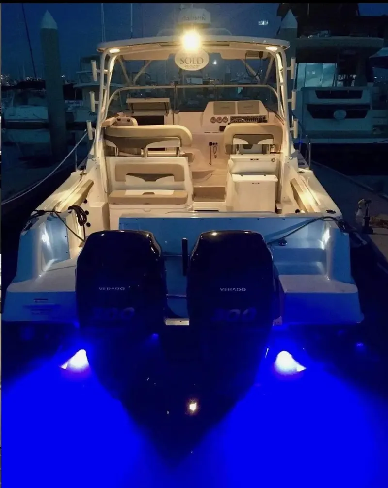 Slide: The Image of 2018 Wellcraft 290 Coastal boat with illuminated blue underwater lights at night. - 49