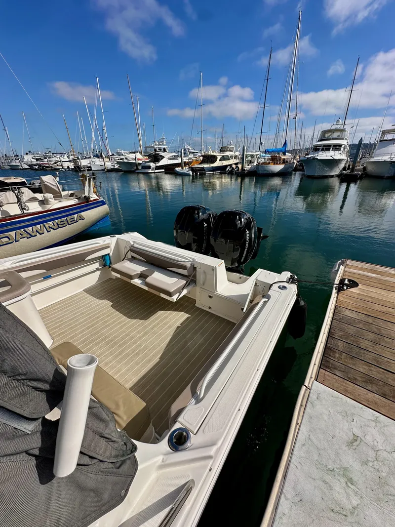 Slide: The Image of 2018 Wellcraft 290 Coastal boat docked in a marina with clear blue skies. - 7