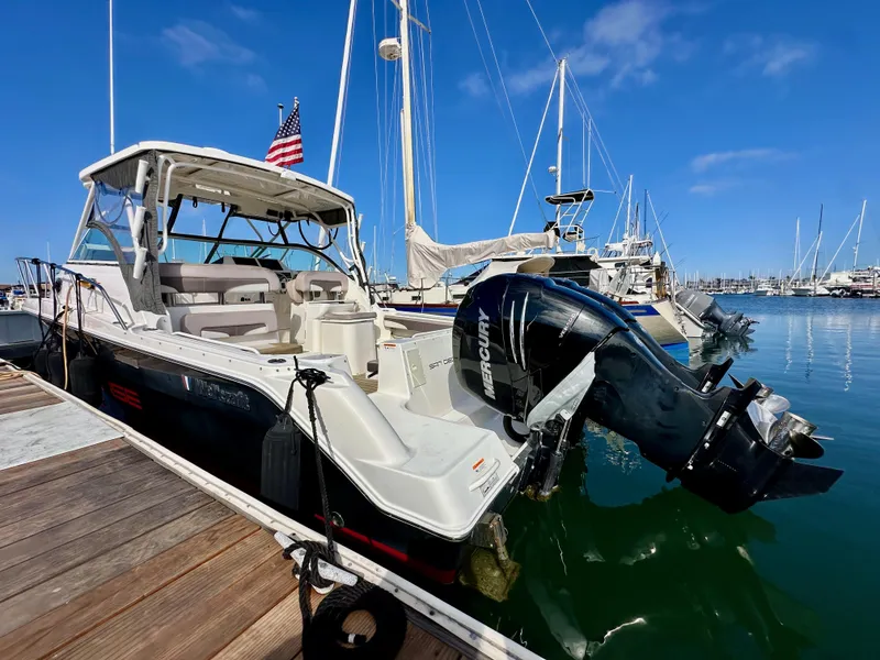 Slide: The Image of 2018 Wellcraft 290 Coastal boat docked with Mercury outboard engine. - 9