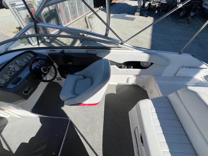 Slide: The Image of Interior of a 2007 Regal 2000 boat with steering wheel and seating. - 11