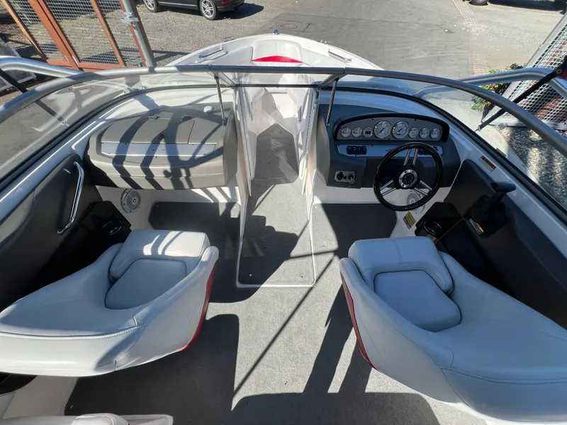 Slide: The Image of Interior of a 2007 Regal 2000 boat with steering wheel and seating. - 12