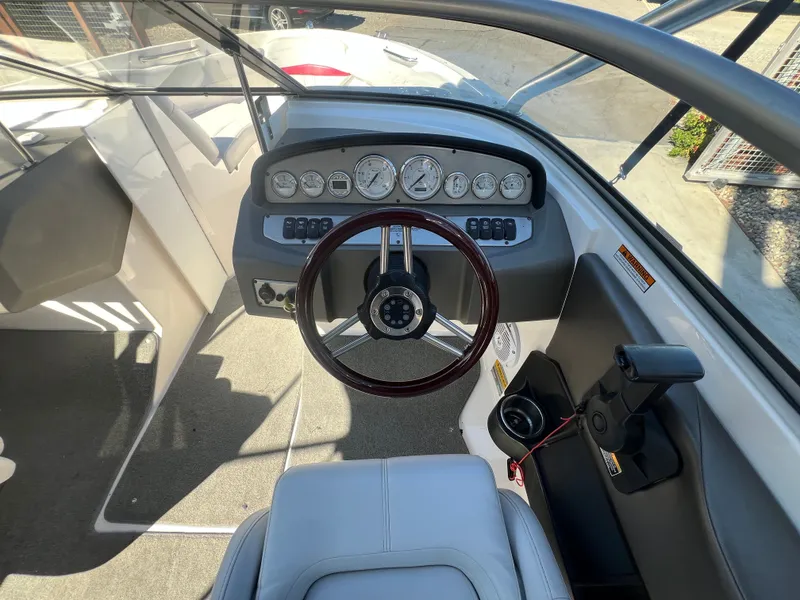 Slide: The Image of Interior view of a 2007 Regal 2000 boat cockpit with steering wheel and dashboard controls. - 15