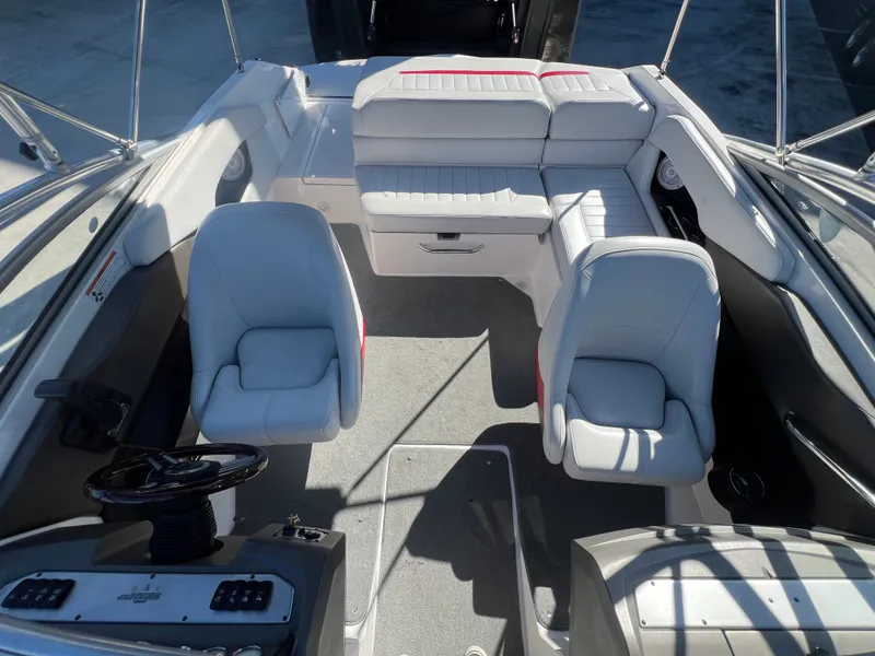 Slide: The Image of Interior of a 2007 Regal 2000 boat with white seating and steering console. - 16