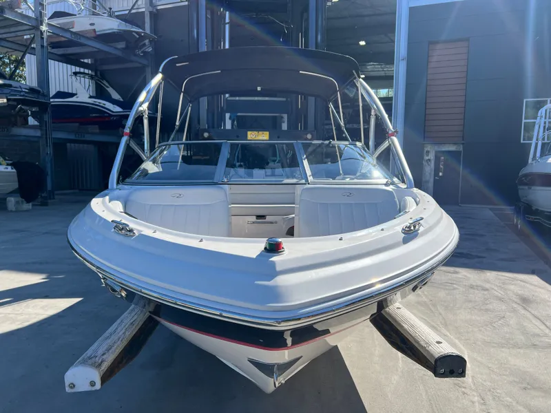 Slide: The Image of 2007 Regal 2000 boat in storage, front view with canopy and sleek design. - 3