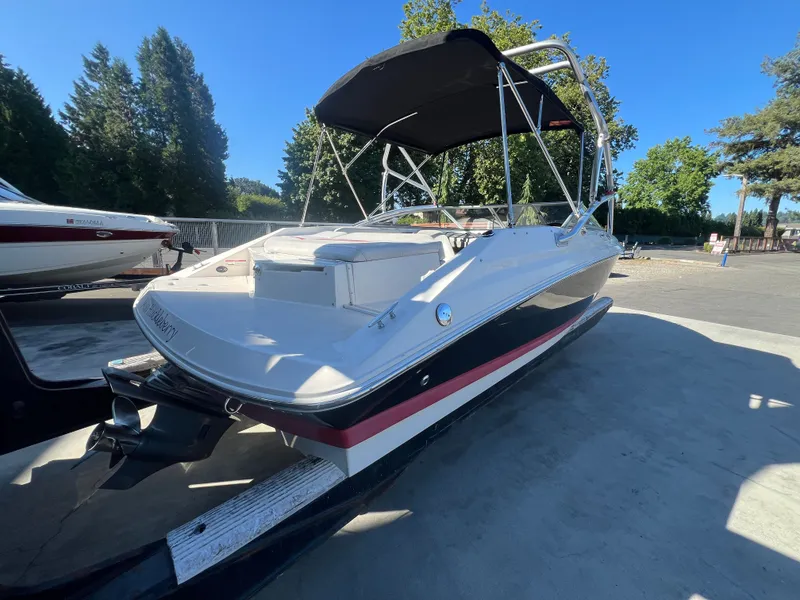 Slide: The Image of 2007 Regal 2000 boat with canopy, parked outdoors on a sunny day. - 6
