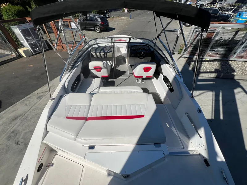 Slide: The Image of 2007 Regal 2000 boat interior with white and red seating, black canopy, and steering console. - 7