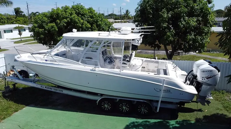 Slide: The Image of 2007 Boston Whaler 320 Outrage Cuddy Cabin on trailer, parked outdoors. - 10