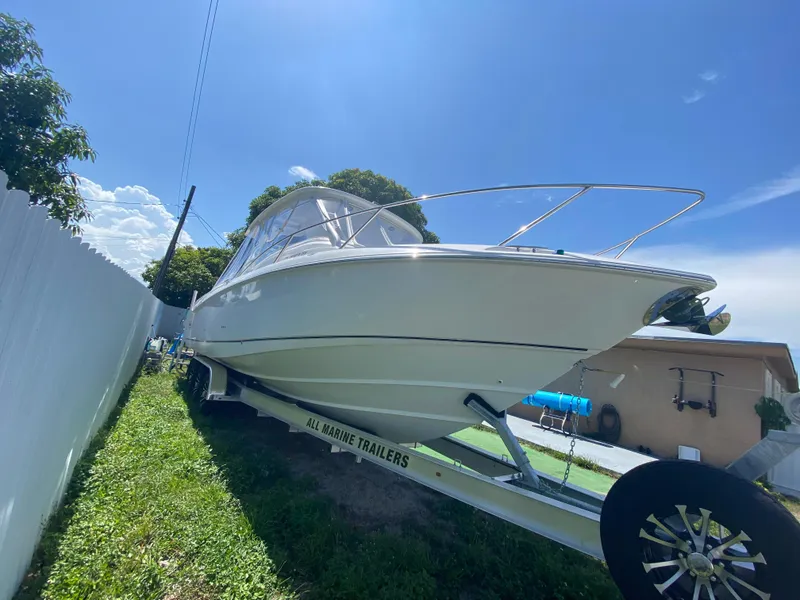 Slide: The Image of 2007 Boston Whaler 320 Outrage Cuddy Cabin on trailer under clear blue sky. - 12