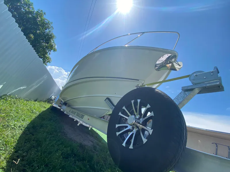 Slide: The Image of 2007 Boston Whaler 320 Outrage Cuddy Cabin on trailer under bright sun. - 13