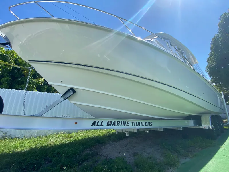 Slide: The Image of 2007 Boston Whaler 320 Outrage Cuddy Cabin on trailer, sunny day, side view. - 14