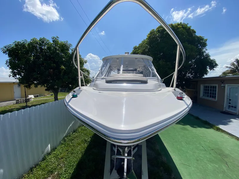 Slide: The Image of 2007 Boston Whaler 320 Outrage Cuddy Cabin boat on display, sunny day, residential background. - 16