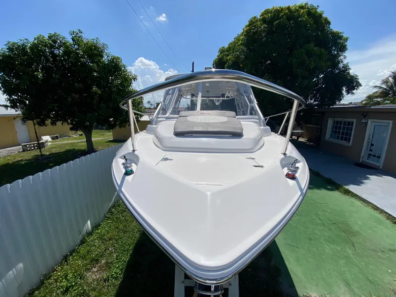 Slide: The Image of 2007 Boston Whaler 320 Outrage Cuddy Cabin, docked outdoors, sunny day. - 17