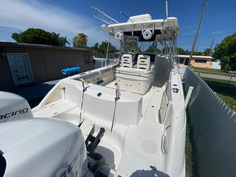 Slide: The Image of 2007 Boston Whaler 320 Outrage Cuddy Cabin boat, docked outdoors, showcasing spacious deck. - 20