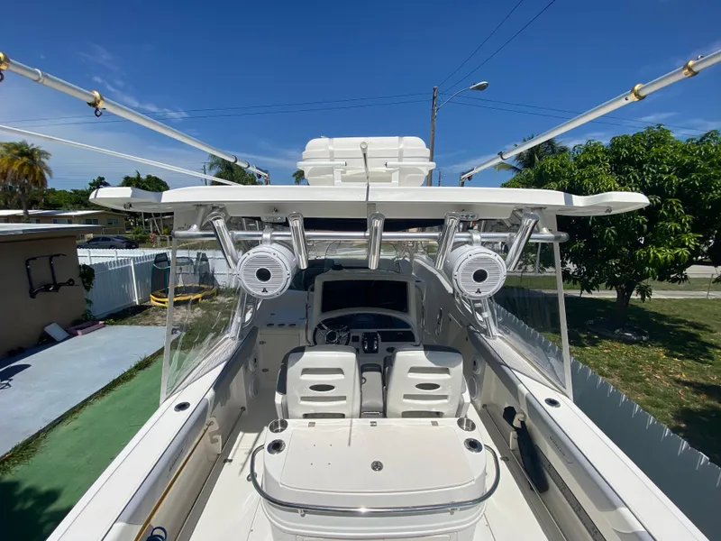 Slide: The Image of 2007 Boston Whaler 320 Outrage Cuddy Cabin boat interior with fishing rod holders and seating. - 21