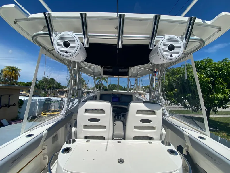 Slide: The Image of 2007 Boston Whaler 320 Outrage Cuddy Cabin interior with seating and speakers. - 22