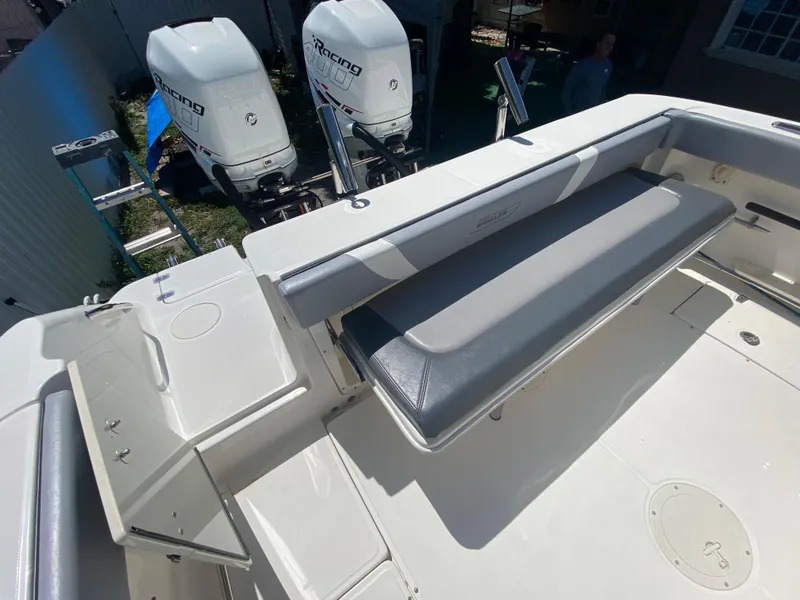 Slide: The Image of 2007 Boston Whaler 320 Outrage Cuddy Cabin with dual outboard engines and seating area. - 23