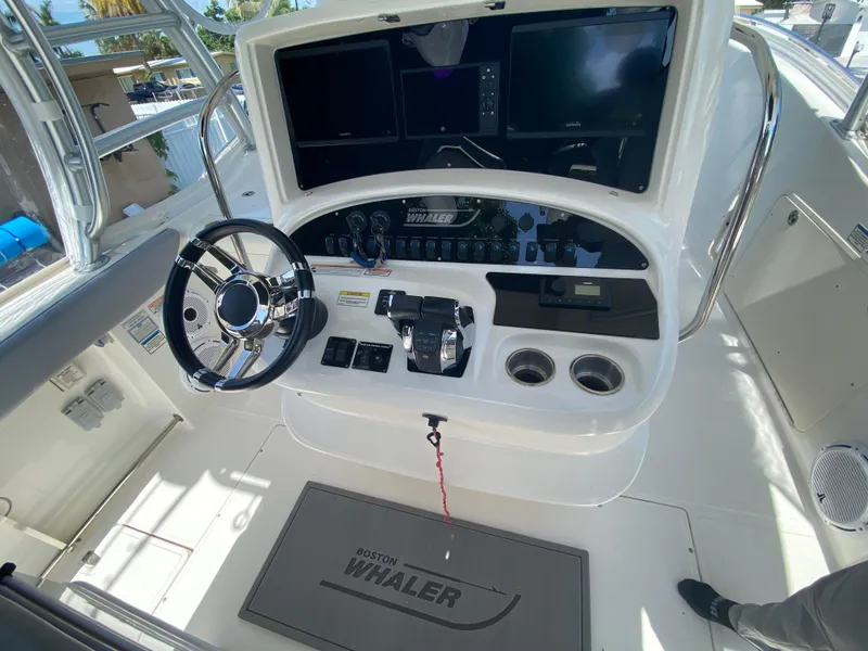 Slide: The Image of 2007 Boston Whaler 320 Outrage Cuddy Cabin helm with steering wheel and controls. - 25