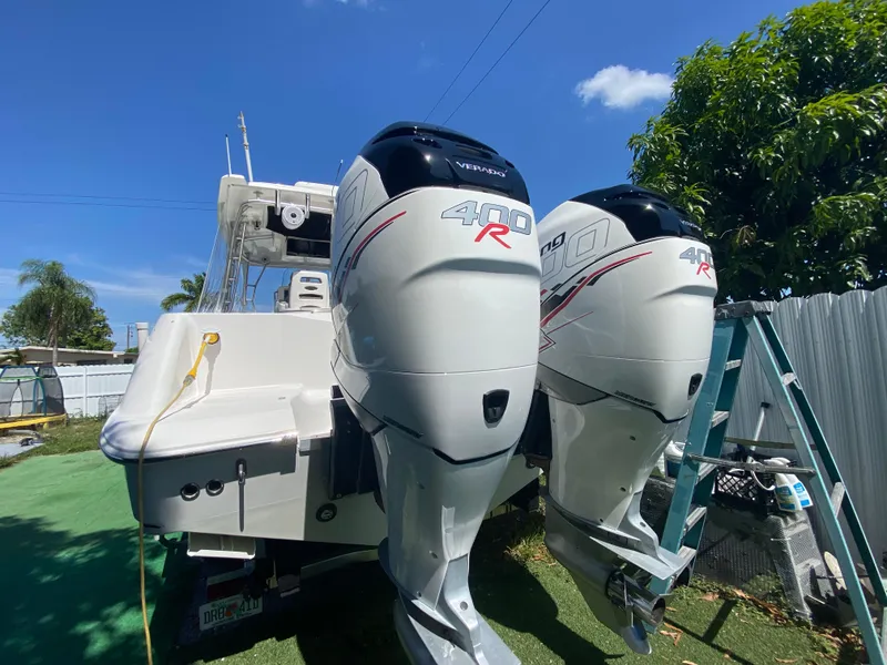 Slide: The Image of 2007 Boston Whaler 320 Outrage Cuddy Cabin with twin 400R engines, parked outdoors. - 28