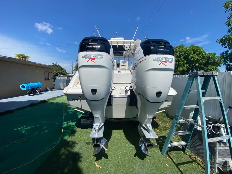 Slide: The Image of 2007 Boston Whaler 320 Outrage Cuddy Cabin with twin 400R engines, parked outdoors. - 30