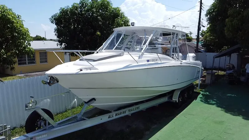 Slide: The Image of 2007 Boston Whaler 320 Outrage Cuddy Cabin on trailer, parked outdoors. - 4