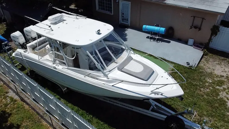 Slide: The Image of 2007 Boston Whaler 320 Outrage Cuddy Cabin on trailer beside house. - 5
