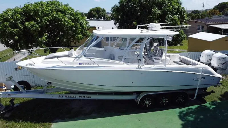 Slide: The Image of 2007 Boston Whaler 320 Outrage Cuddy Cabin on trailer, parked outdoors. - 6