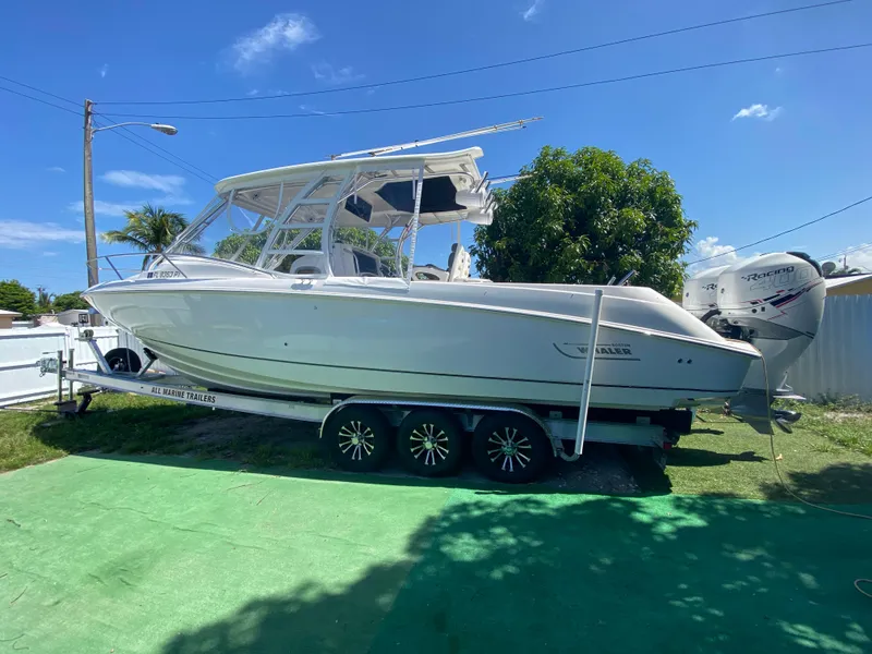 Slide: The Image of 2007 Boston Whaler 320 Outrage Cuddy Cabin on trailer, sunny day, green grass. - 8