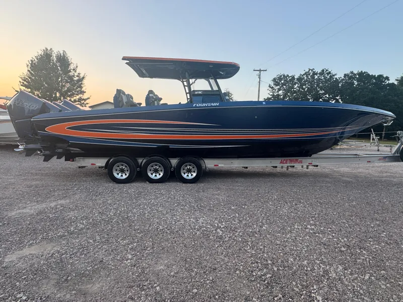 Slide: The Image of 2023 Fountain 38 SC boat on trailer at sunset, side view. - 0