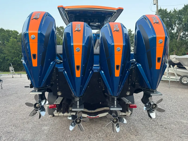 Slide: The Image of 2023 Fountain 38 SC boat with four powerful outboard motors, blue and orange design. - 14