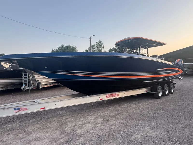 Slide: The Image of 2023 Fountain 38 SC boat on trailer at sunset, side view. - 19
