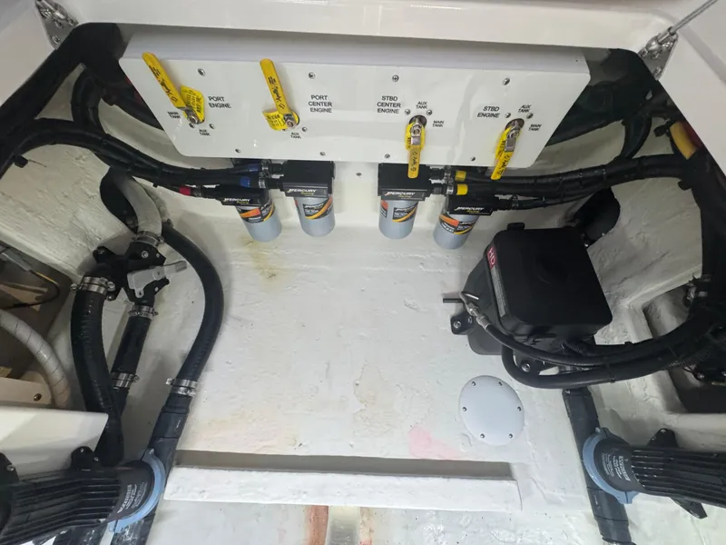 Slide: The Image of Engine compartment of 2023 Fountain 38 SC boat with fuel filters and control panel. - 27