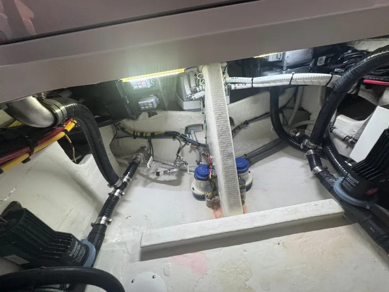 Slide: The Image of Engine compartment of 2023 Fountain 38 SC boat, showcasing wiring and mechanical components. - 29