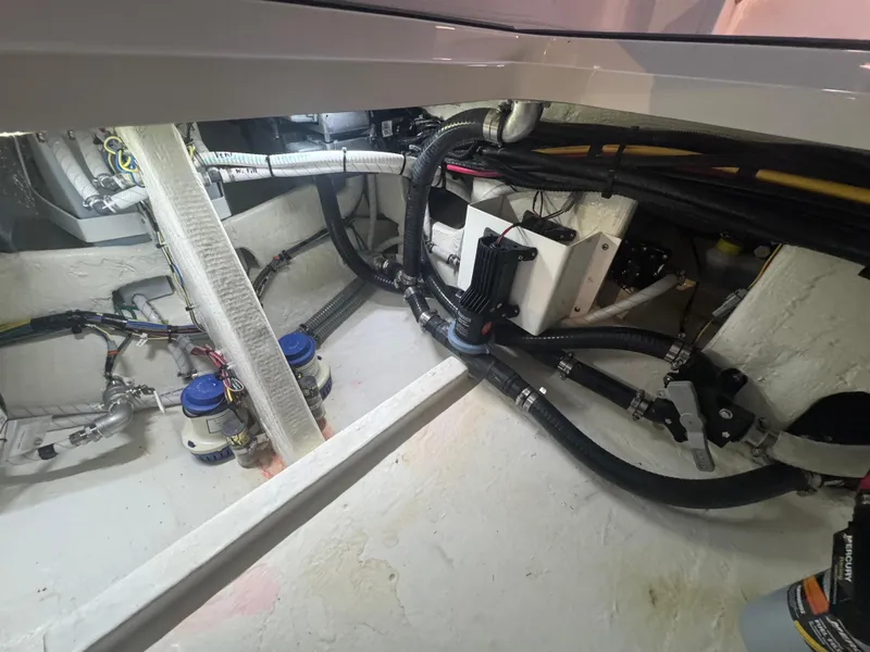 Slide: The Image of Engine compartment of 2023 Fountain 38 SC boat, showcasing hoses and mechanical components. - 30