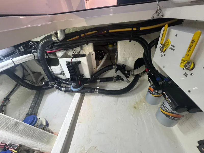 Slide: The Image of Engine compartment of 2023 Fountain 38 SC boat with visible hoses and filters. - 31