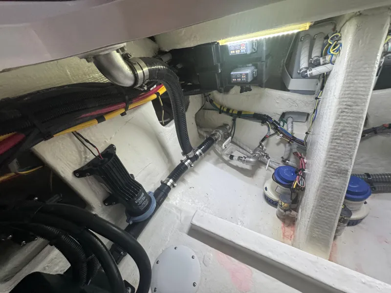 Slide: The Image of Engine compartment of 2023 Fountain 38 SC boat, showcasing wiring and mechanical components. - 32